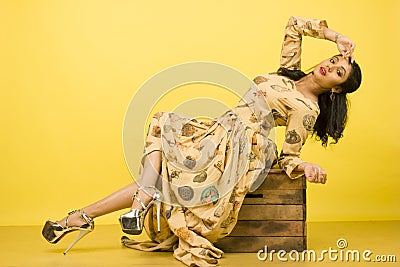 Beautiful female model in beige flowy dress Stock Photo