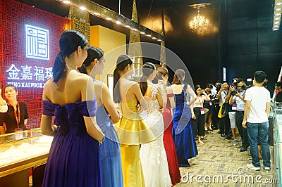 Beautiful female models show gold jewelry at the Shenzhen International Jewelry Show Editorial Stock Photo