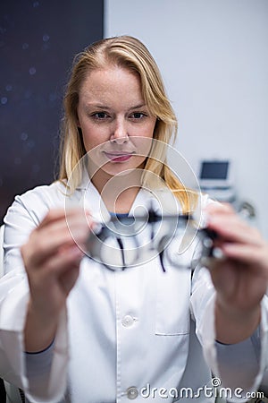 Beautiful female optometrist holding messbrille Stock Photo
