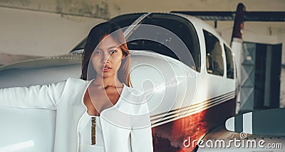 Beautiful female portrait in the airplane hangar, with modern ai Stock Photo