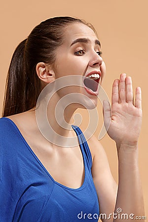 The young woman is calling on the pastel background. Stock Photo