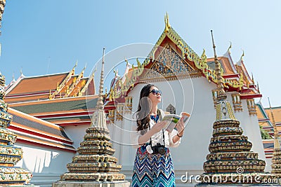 Beautiful female traveler holding guidebook Stock Photo