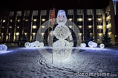 Beautiful festive luminous snowmen from electric garlands Stock Photo