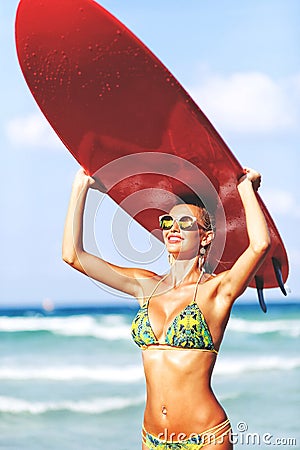 Beautiful fit woman with surfboard on a beach Stock Photo