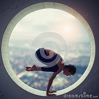 Beautiful sporty fit yogi woman practices yoga asana Natarajasana - Lord Of The Dance pose in a round window Stock Photo