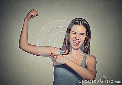 Beautiful fit young healthy model woman flexing muscles showing her strength Stock Photo