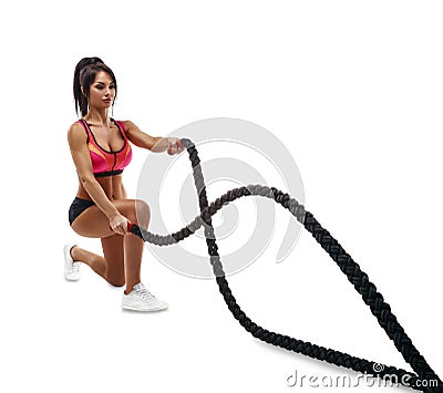 Beautiful fitness girl doing training using crossfit rope Stock Photo