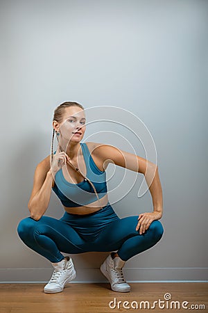 Beautiful fitness model showing copy space on gray background. Close-up. fitness motivation, sports banner. Healthy Stock Photo