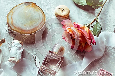 Beautiful flat barking in gently pink colors: perfume, box with ring, rose, satin ribbon, macaroon Stock Photo