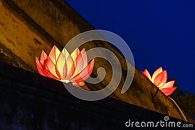 Beautiful flower garlands and colored lanterns on ancient architectural building Stock Photo