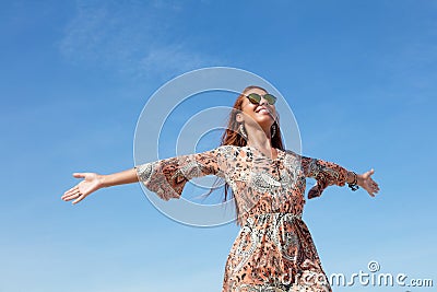 Beautiful flower power woman with copy space in blue sky outdoor Stock Photo