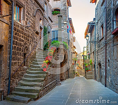 Beautiful flower street in a medieval village in Tuscany. Stock Photo