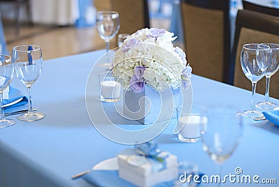 Beautiful flowers and candles on table in wedding day.Blue color decoration tablecloth Stock Photo