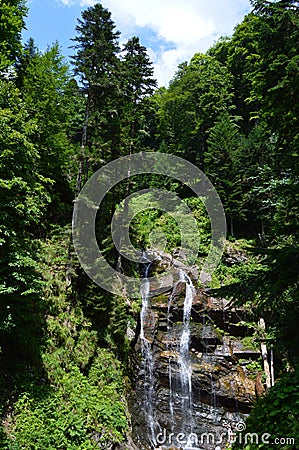 Beautiful flowing fountain over the mountain in the tropics Stock Photo