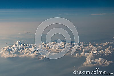 Beautiful fluffy clouds from the window of the plane. Stock Photo