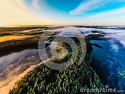 Beautiful foggy morning, aerial landscape. Lakes and green forest at sunrise. Ecology concept Stock Photo