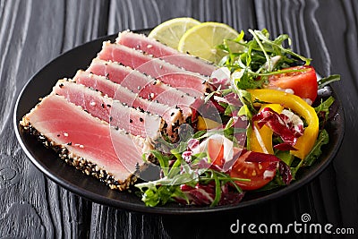 Beautiful food: steak tuna in sesame, lime and fresh salad close Stock Photo