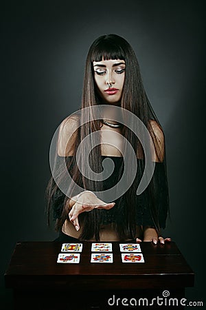 Beautiful fortune teller with tarot cards Stock Photo