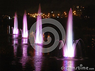 Beautiful fountains with evening illumination. Rusanovka. Kiev. Stock Photo