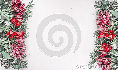 Beautiful fresh bush roses lined with frame on a white rustic wooden background, space for text, top view Stock Photo