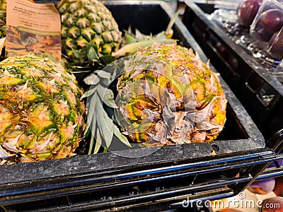 Beautiful fresh pineapples are being sold in a supermarket shelf in a supermarket Stock Photo
