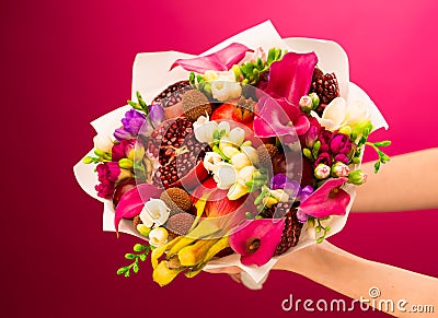 Flowers, fruit bouquet, pink callas, garnet, lychees, freesia, p Stock Photo
