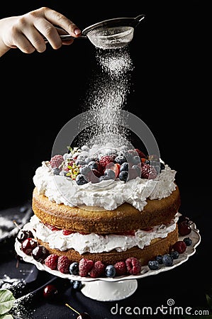 Beautiful, fruit naked cake on a dark tablecloth Stock Photo