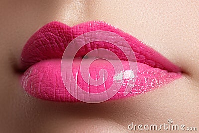 Beautiful full pink lips and white teeth. Pink lipstick. Gloss lips. Make-up & Cosmetics Stock Photo