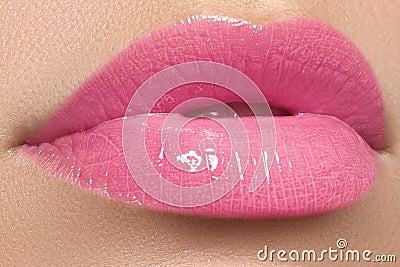 Beautiful full pink lips and white teeth. Pink lipstick. Gloss lips. Make-up Stock Photo