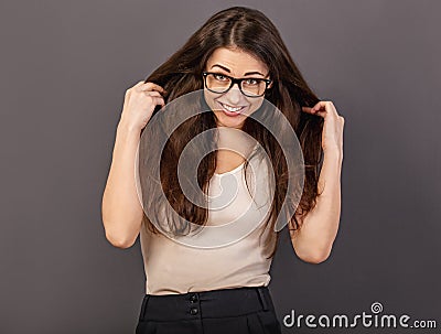 Beautiful fun humor toothy laughing smiling business woman in glasses holding the hands long brown hair in white shirt on grey Stock Photo