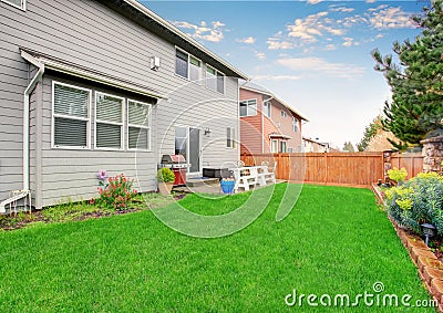 Beautiful furnished back yard with patio and fence. Stock Photo