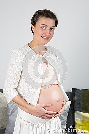 A beautiful future mother holds her hands Stock Photo