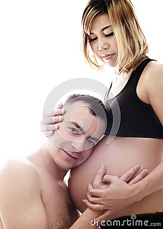 Beautiful future parents: his pregnant asian wife and a happy husband with new life Stock Photo