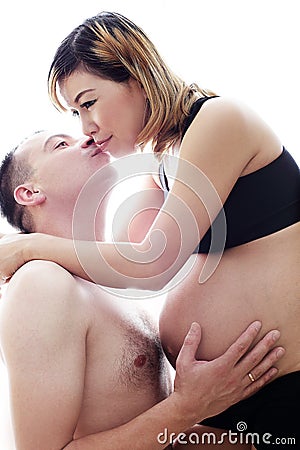 Beautiful future parents: his pregnant asian wife and a happy husband with new life for family complete Stock Photo