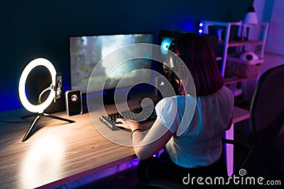 Beautiful gamer enjoying her time playing online Stock Photo