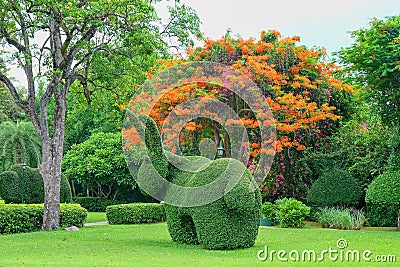 Beautiful garden art decoration on blossom exotic trees background in the park Stock Photo