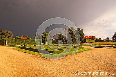 Beautiful garden in famous baroque palace Jaromerice nad Rokytnou against the dark thunderclouds Stock Photo