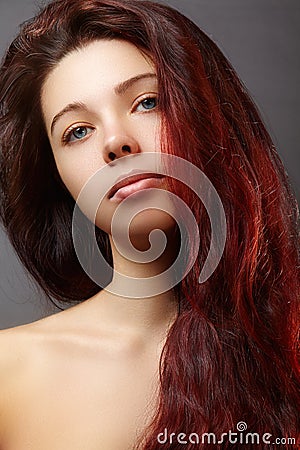 Beautiful ginger young woman with luxury hair style and fashion gloss makeup. Beauty closeup model with red hair Stock Photo