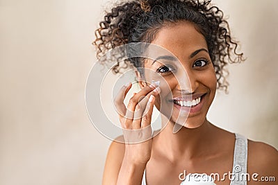 Beautiful girl applying face cream Stock Photo