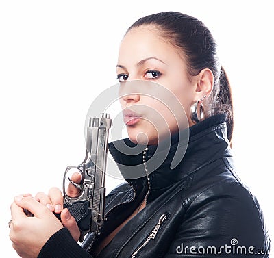 Beautiful girl in black jacket and beretta gun in her hands Stock Photo