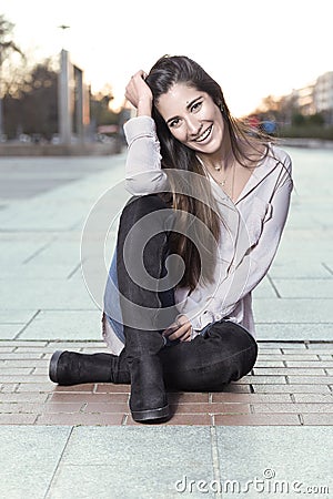 Beautiful girl in boots sitting on the floor Stock Photo