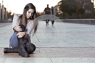 Beautiful girl in boots sitting on the floor Stock Photo