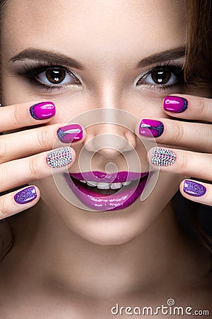 Beautiful girl with a bright evening make-up and purple manicure with rhinestones. Nail design. Beauty face. Stock Photo