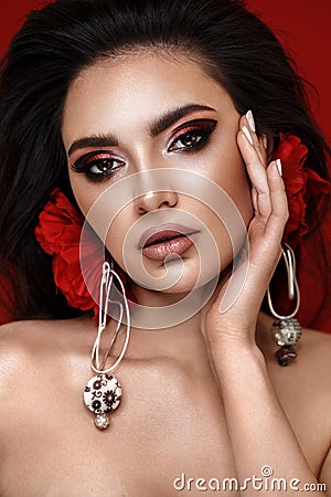 Beautiful girl with bright fashionable make-up and unusual red accessories. Beauty face. Stock Photo