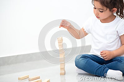 Beautiful girl builds a tower. Stock Photo