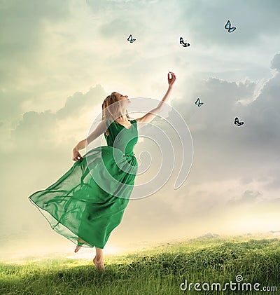 Beautiful girl catching butterflies on a mountain Stock Photo