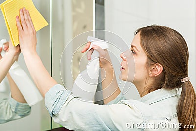 Beautiful girl cleaning up her house Stock Photo