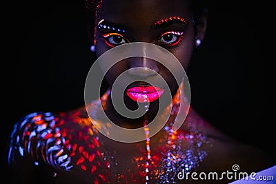 Beautiful girl with creative fluorescent prints on skin Stock Photo