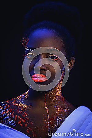 Beautiful girl with creative fluorescent prints on skin Stock Photo
