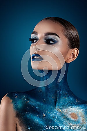 Beautiful girl with creative make-up . Bright colors blue lips. Conceptual art the cosmos, the universe Stock Photo